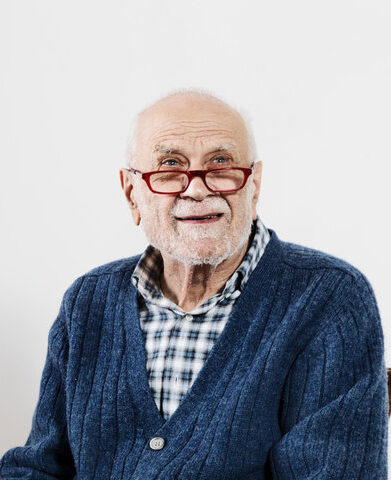 older man smiling with glasses on