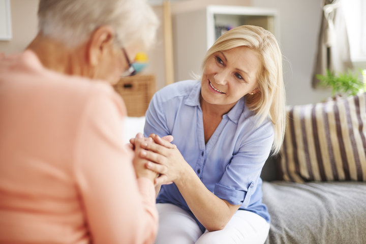 woman with mum giving her  reassruance  