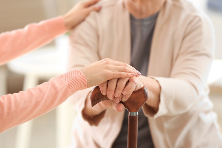 older woman with walking stick