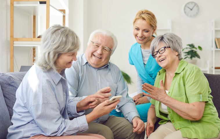 people looking at a phone and talking about care