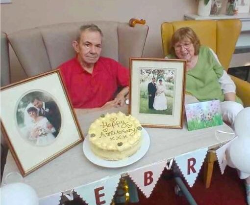 a couple celebrating their wedding anniversary with pictures and cake